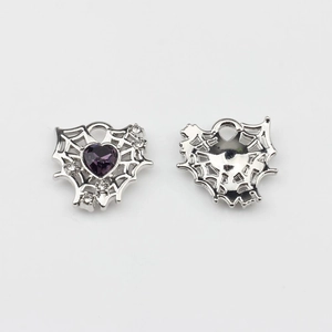 Detail of silver alloy heart pendants with spider web design and purple zircon stones