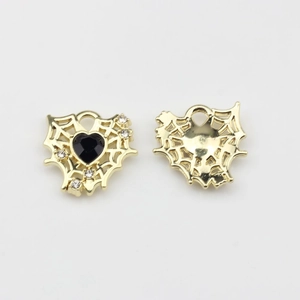 Macro detail of 17mm gold mesh heart charms with black stone and zircons for jewelry making
