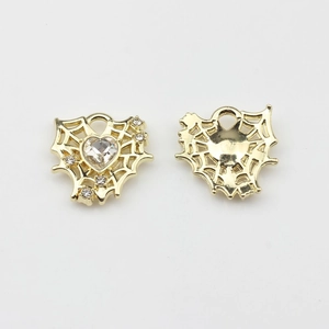Detailed view of gold alloy heart pendant with mesh cut-out and sparkling zircon stone