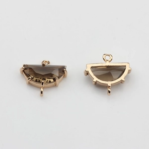 Macro view of gold-plated fan-shaped crystal pendants with double rings for DIY jewelry
