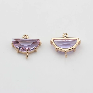 Macro shot of semi-circle light purple crystal pendants with gold-plated metal frames