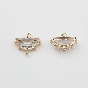 Detailed view of gold-plated semi-circle pendants with clear cubic zirconia for DIY jewelry