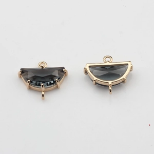 Detailed view of semi-circular smoke grey crystal charms with gold-plated double loops