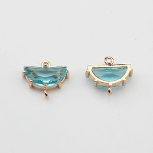 Detail of light blue crystal fan pendants in rose gold plated frames with dual rings