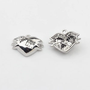 Close-up of silver heart pendants with square zircon and star rhinestone details