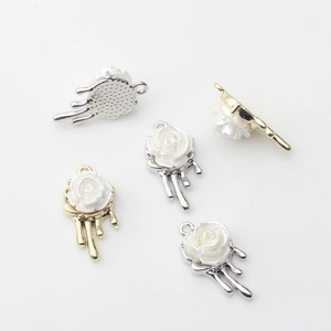 Detailed view of DIY rose flower pendants with imitation pearls and metal base loops