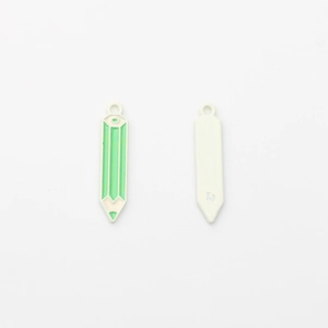 Detail view of pencil-shaped enamel pendants in green and beige with top hanging rings