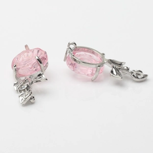 Detailed view of silver rose pendants with pink resin petals and crystal accents