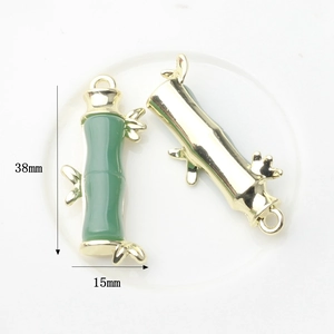 Bamboo pendant detail showing 38x15mm dimensions with green enamel and gold finish
