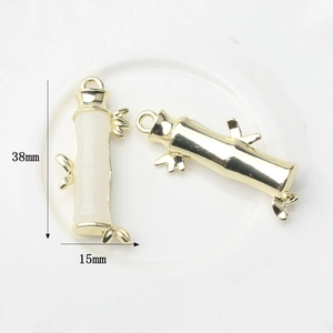 Detailed view of bamboo joint pendants in gold and imitation jade for DIY jewelry making