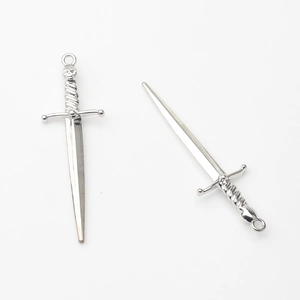 Detailed macro view of silver alloy sword pendants for DIY jewelry making