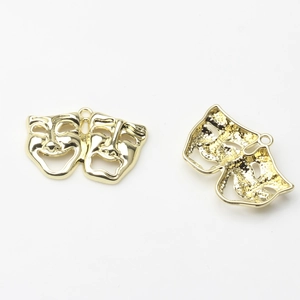 Detailed front and back view of golden theater mask charms for DIY jewelry making