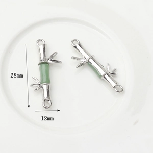 Detailed macro of bamboo-shaped faux jade connectors with silver metal for DIY jewelry