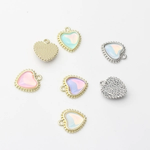 Macro shot of heart-shaped iridescent alloy pendants in gold and silver finishes