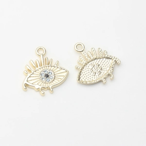 Detailed front and back views of gold evil eye charms with blue zircon inlay and eyelashes