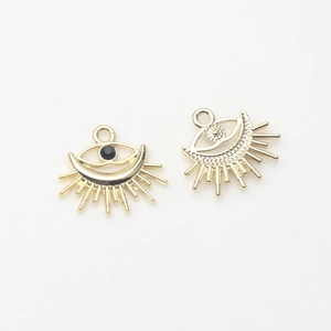 Macro view of gold evil eye pendants with black zircon and ray texture for DIY jewelry