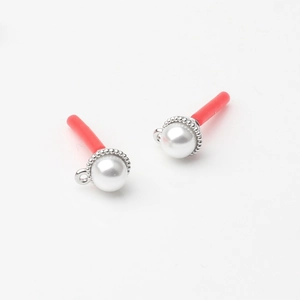 Detailed view of imitation pearl earring components with silver beaded metal base and hoop