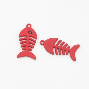 Detail of red fishbone alloy pendants with matte finish for DIY jewelry making
