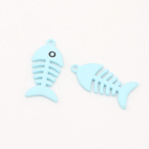 Detail of two light blue fishbone alloy pendants with smooth matte finish for DIY jewelry