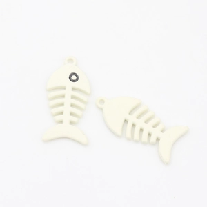 Macro view of cream white fish bone charms with top hanging loops for jewelry making