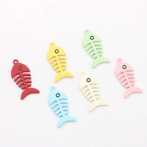 Flat lay of colorful fish bone pendants for DIY jewelry making in six pastel matte shades