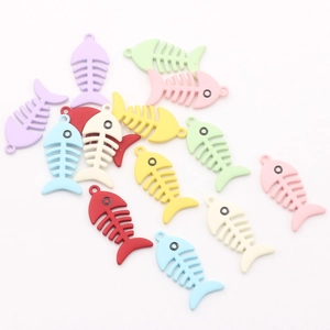 Macro shot of colorful fishbone charms with hanging holes for DIY jewelry making