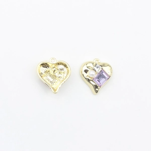 Detail of heart-shaped gold alloy pendants with purple gemstones and pearls for DIY jewelry