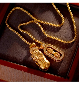 Detail of Pixiu and Vajra pendants in matte gold with sparkling inlaid diamonds