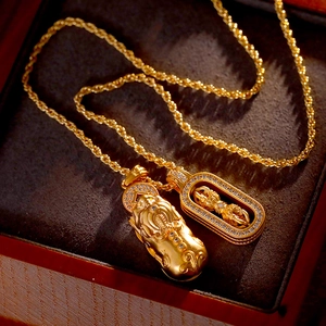 Golden Pixiu and Vajra pendant necklace set on dark velvet luxury jewelry box