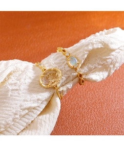 Detailed macro view of vintage gold ring set with colorful opal and oval yellow stone