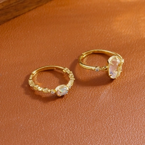 Vintage gold rings with opal and yellow stone on leather background, adjustable design