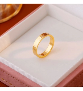 Detail of 18k gold plated ring with honeycomb texture and mirror finish in a velvet box