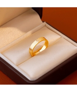Detail of gold-plated ring with honeycomb hammered texture in a brown luxury jewelry box