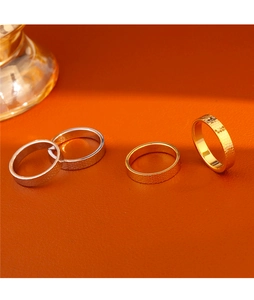 Detailed close-up of textured and polished 18k gold plated minimalist stacking rings