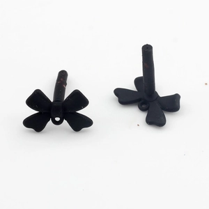 Detailed view of matte black bow-shaped earring posts with connector loops for jewelry making