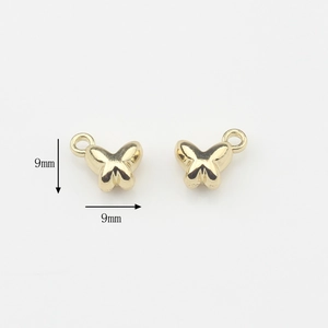 Detalle macro de colgantes de mariposa 3D dorados de 9 mm para joyería DIY