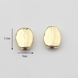 Vista macro de cuentas de metal dorado martillado de 11x9mm para creación de joyas DIY