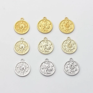 Set of nine round flower coin charms in gold and silver for DIY jewelry making