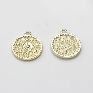 Detailed view of golden coin pendants with daisy pattern and frosted texture back