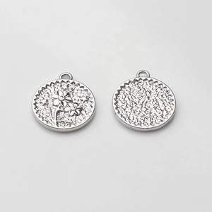 Detailed front and back views of silver-toned round flower coin pendant with star engravings