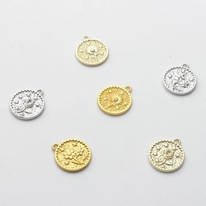 Set of round gold and silver flower coin pendants for DIY jewelry making with sunflower relief