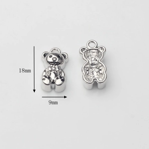 Detail view of 18mm silver alloy bear pendant showing front and hollow back for DIY jewelry