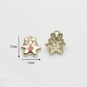 Detail view of 16mm gold cartoon bear charms with pink hearts and pearl accents