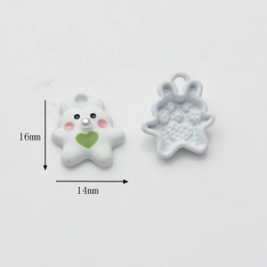 Macro detail of 16mm x 14mm white resin rabbit pendant with green heart and loop for DIY