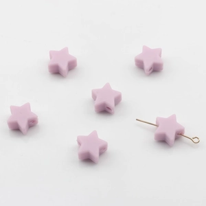 Gros plan de perles en silicone étoile lavande de 14mm avec trou central pour DIY