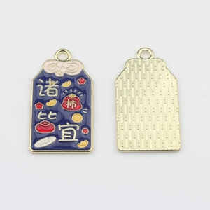 Detailed front and back of rectangular enamel lucky charm with gold motifs and stripes