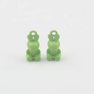 Detail view of two light green rabbit-shaped alloy charms for DIY jewelry making