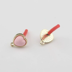 Detailed close-up of pink enamel heart charms with gold edges and textured metal backing