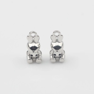 Detailed close-up of two polished silver bunny alloy pendants for DIY jewelry making