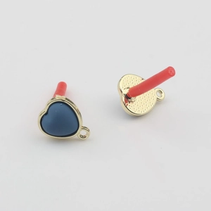 Macro shot of blue heart pendant charms with gold metal bases and hanging loops
